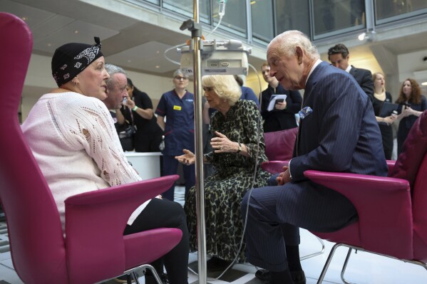 Britain's King Charles III and Queen Camilla meet with Lesley Woodbridge, patient receiving the second round of chemotherapy for sarcoma and her husband Roger Woodbridge during a visit to the University College Hospital Macmillan Cancer Centre in London, Tuesday April 30, 2024. (Suzanne Plunkett, Pool Photo via AP, File)