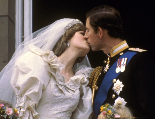 Britain's Prince Charles kisses his bride, Princess Diana, on the balcony of Buckingham Palace in London, July 29, 1981, after their wedding. (AP Photo, File)